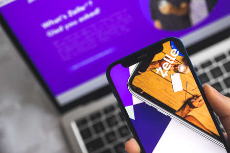 Woman use Zelle app. Mobile phone banking and investment concept photoのeditorial素材