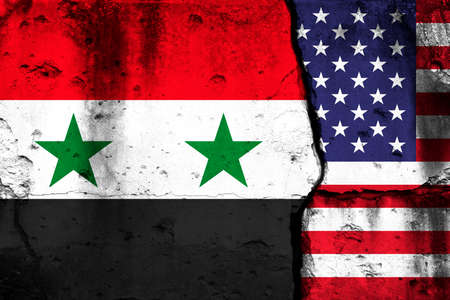 United States and Syria crisis. Background with national flags on cracked wallの写真素材