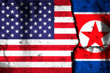 United States and North Korea crisis. Background with national flags on cracked wallの写真素材