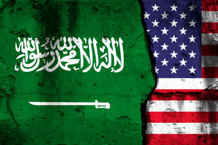 United States and Saudi Arabia crisis. Background with national flags on cracked wallの写真素材