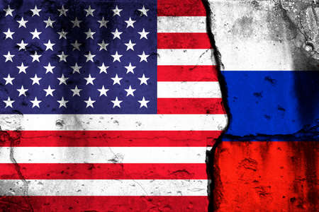 United States and Russia crisis. Background with national flags on cracked wallの写真素材