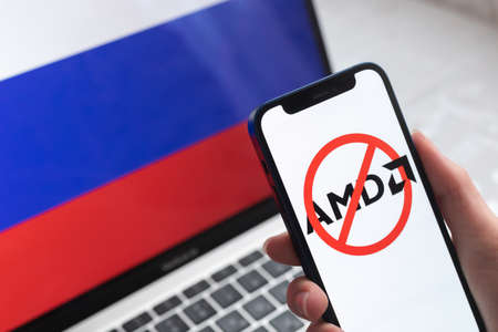 SPB, Russia - April 8, 2022: AMD in Russia. Blocked and banned service, EU sanctions. Mobile phone with , russian flag background photoのeditorial素材