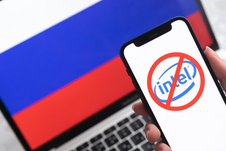 SPB, Russia - April 8, 2022: Intel in Russia. Blocked and banned service, EU sanctions. Mobile phone with , russian flag background photoのeditorial素材