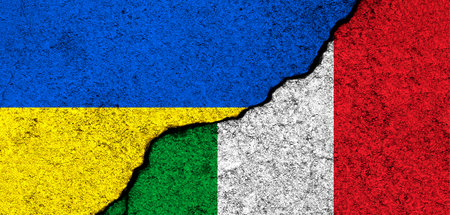 Ukraine and Italy flags. Support and help, weapons and military equipment, partnership and diplomacy, humanitarian aid and donations for Ukrainian refugees conceptの写真素材