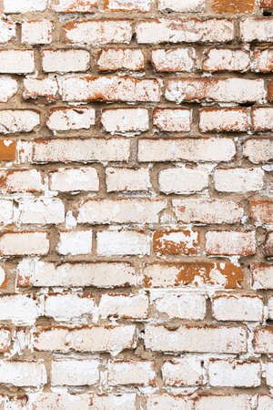Old brick wall with weathered white paint, high detailed texture backgroundの写真素材