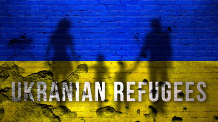 Refugee in Ukraine background. Silhouettes of family with children against Ukrainian flag, cracked and damaged brick wallの写真素材