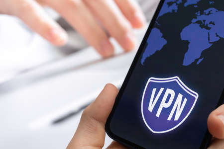 Person uses VPN technology on mobile phone. Anonymous and secure internet access concept backgroundの写真素材
