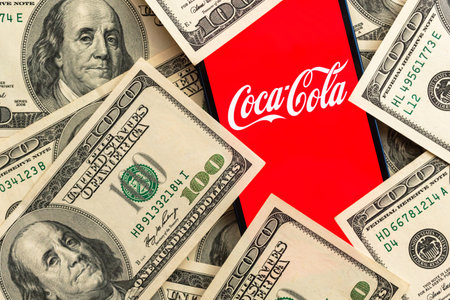 Coca-cola stock market price. close-up view and dollar money background. Business and finance concept photoのeditorial素材