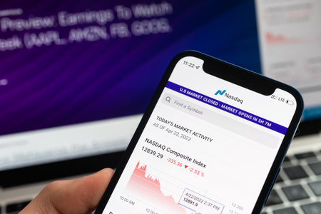 SPB, Russia - April 25, 2022: Person uses Nasdaq market app on mobile phone. finance stock companyのeditorial素材