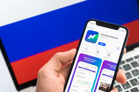 SPB, Russia - April 25, 2022: Nasdaq closed in Russia. Mobile phone with application icon close-up view. finance stock companyのeditorial素材