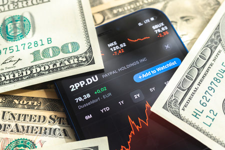Poltava, Ukraine - April 28, 2022: Paypal stock trade market background, finance and business concept with dollar money banknotes closeupのeditorial素材