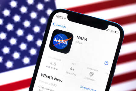 Poltava, Ukraine - April 28, 2022: NASA app  against American flag, USA background photoのeditorial素材