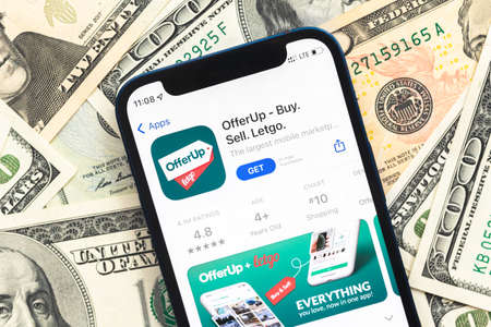 Poltava, Ukraine - April 28, 2022: OfferUP shopping app on mobile phone screen. Business background with dollar money banknotesのeditorial素材