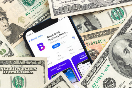 Poltava, Ukraine - April 28, 2022: Bloomberg mobile application, business background with dollar banknotes photoのeditorial素材