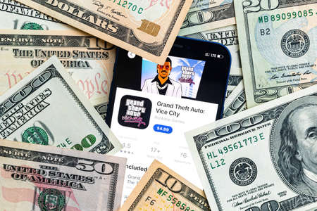 GTA Vice City mobile game app. Money background. Concept, company making money with popular mobile phone gamesのeditorial素材