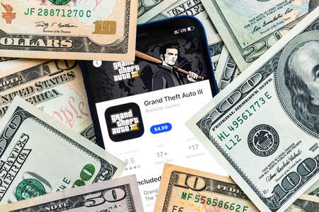 GTA III mobile game app. Money background. Concept, company making money with popular mobile phone gamesのeditorial素材