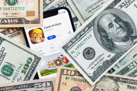 Clash of Clans mobile game app. Money background. Concept, company making money with popular mobile phone gamesのeditorial素材