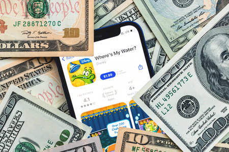 Wheres my water mobile game app. Money background. Concept, company making money with popular mobile phone gamesのeditorial素材