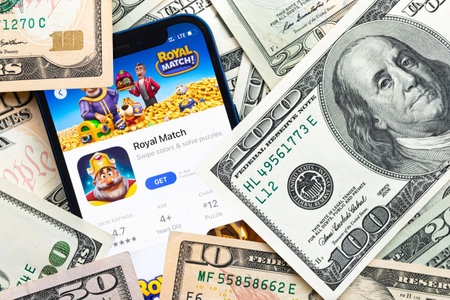 Royal Match mobile game app. Money background. Concept, company making money with popular mobile phone gamesのeditorial素材