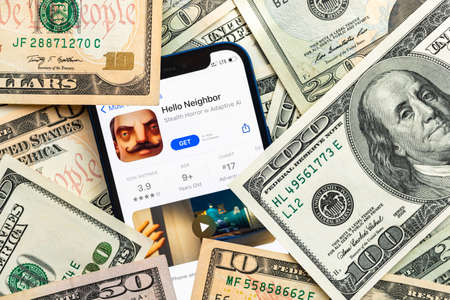 Hello Neighbor mobile game app. Money background. Concept, company making money with popular mobile phone gamesのeditorial素材