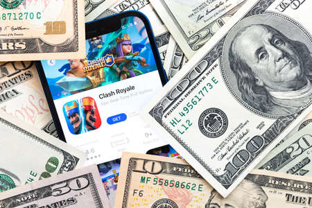 Clash Royale mobile game app. Money background. Concept, company making money with popular mobile phone gamesのeditorial素材