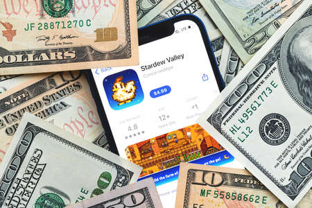 Stardew Valley mobile game app. Money background. Concept, company making money with popular mobile phone gamesのeditorial素材