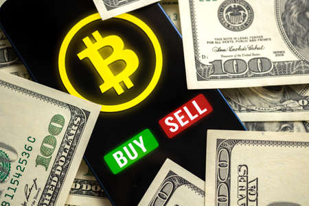 Bitcoin trading concept. Mobile phone application for cryptocurrency. Buy and sell new virtual money. Money dollars background, financial investmentの写真素材