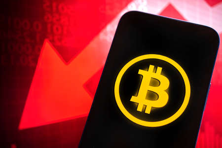 Data analysis in exchange stock market, Bitcoin logo on red stock market chart backgroundの写真素材