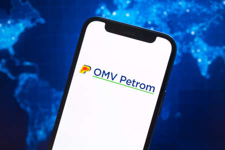 OMV Petrom logo company, gas and oil prices, energy industry. Petroleum stock market graphs, global financial background. Gasoline and diesel conceptのeditorial素材