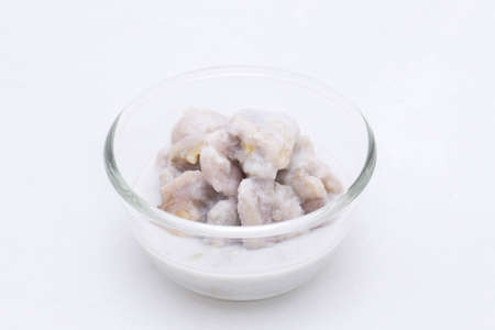 bananas in coconut sauce .Read Thai and name Kluay Buat Chi.Thai desserts Use banana and coconut milk As raw material.On a white backgroundの写真素材