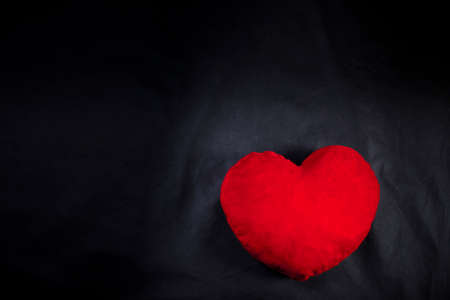 Red heart on black background And free space for text.の写真素材