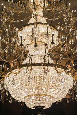 image  crystal chandelier whith Spherical.Crystal made chandeliers light orange.On the ceiling .Select focus pointの写真素材