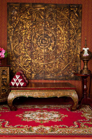 Ancient Thai scenes in a photo studio.The wood is carved into beautiful patterns.Consists of a table, cabinet, water bowlの写真素材