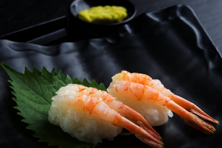 Creative Japanese food.IBotan Ebi Sushi on black background