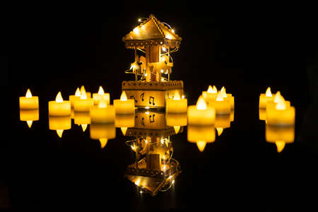 Toy carousel under night light.In the yellow light, a carriage carriage music box.Reflecting the shadow like floating in the middle of the lake.select focus         の写真素材