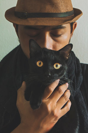 Cat's eyes look instead of human eyes.Love the relationship between two different lives.Still the same smell of lifeの写真素材