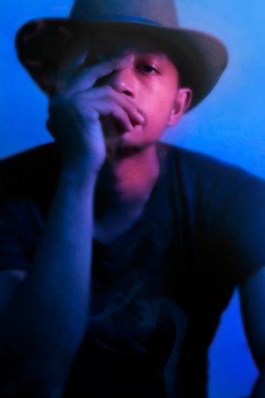 Men are attractive in thinking postures.in the middle of the smoke and red and blue lights