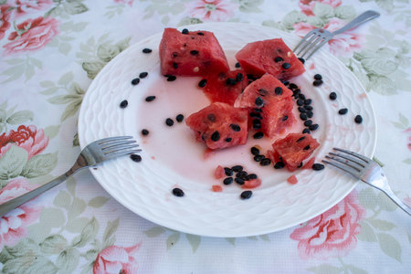 A plate of watermelon. Watermelon seeds on empty plate