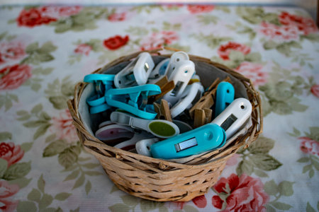 Clothespins in a wooden basket. Colorful Clothespins