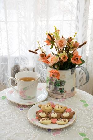 Teddy cookies with a cup of tea.の写真素材