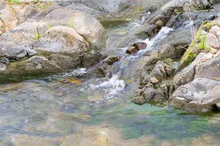 Waterfall was coming down from the mountain cliff.の写真素材