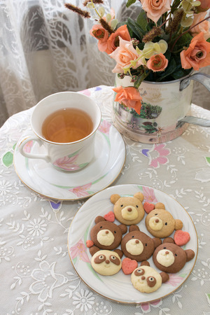 Teddy cookies with a cup of tea.の写真素材