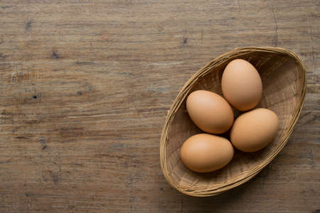 Eggs on wood backgroundの写真素材