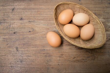 Eggs basket on wooden backgroundの写真素材