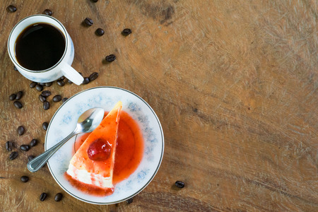 Strawberry crepe cake and a cup of coffee on wooden backgroundの写真素材