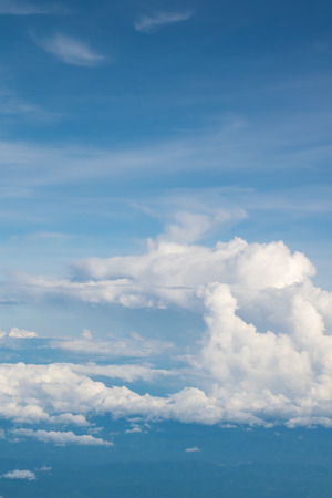 Blue sky and clouds. view from the window of an airplane flying in the cloudsの写真素材