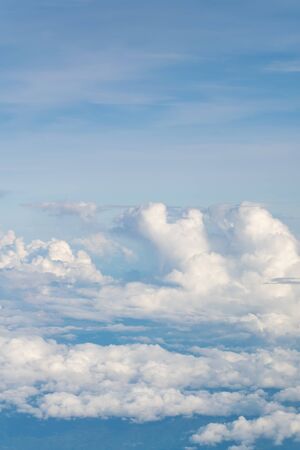 Blue sky and clouds. view from the window of an airplane flying in the cloudsの写真素材