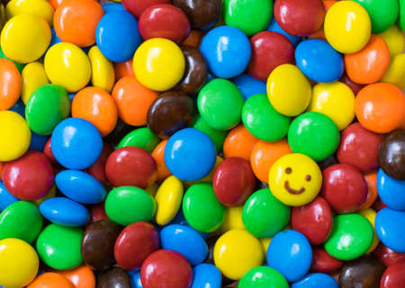 Top view ; Smile face on colorful chocolate ballsの写真素材