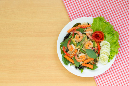 Thai food ; Spaghetti with spicy prawn and basil leaves on wooden backgroundの写真素材