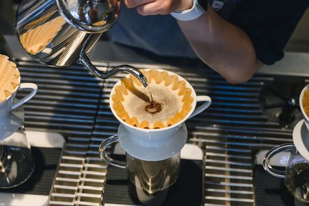Barista making drip coffee in coffee shopの写真素材